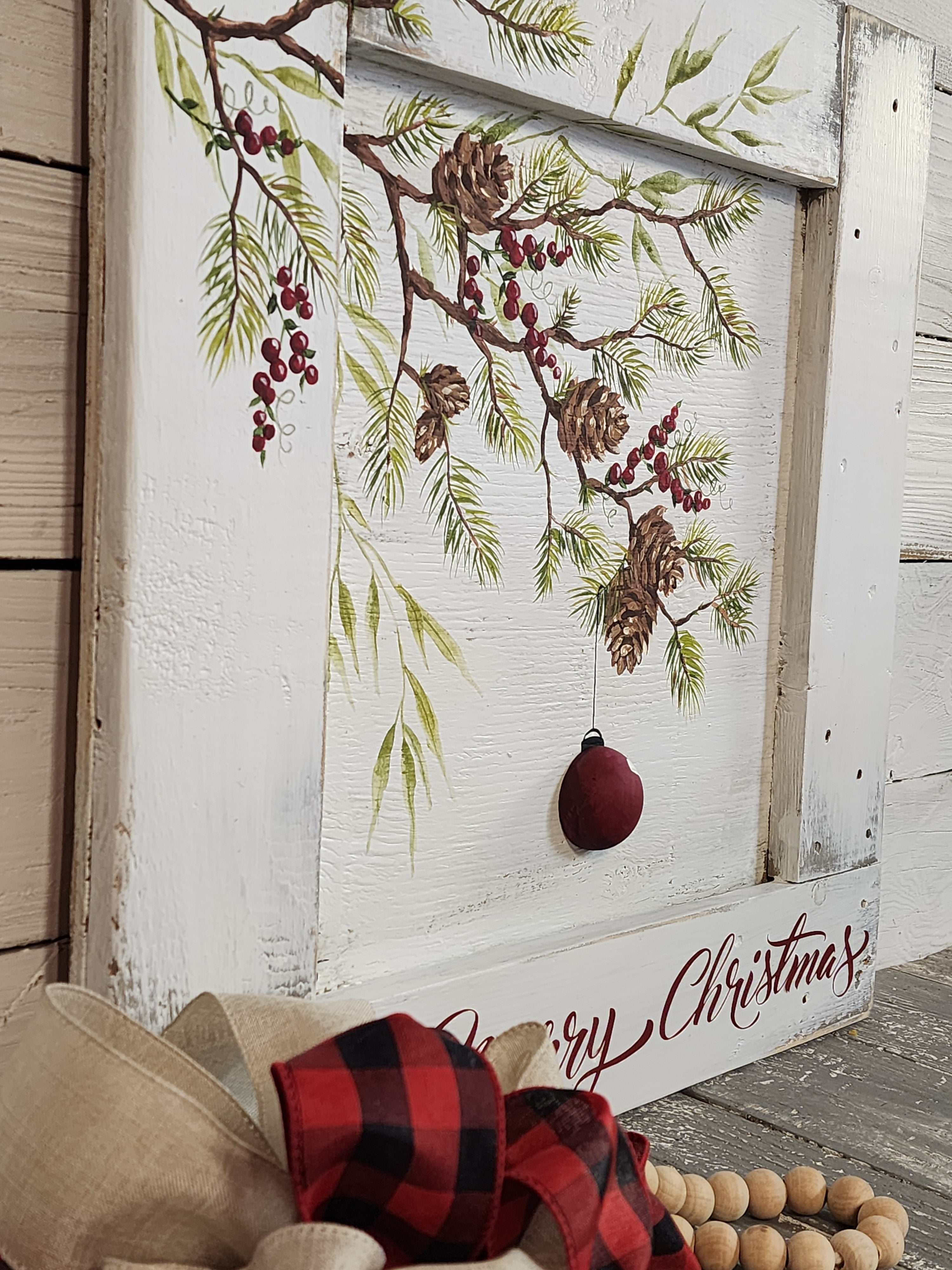 Christmas pine branches and pine cones with 3-d red bulb, painted holiday red berries recycled pallet wood, framed farmhouse Christmas decor