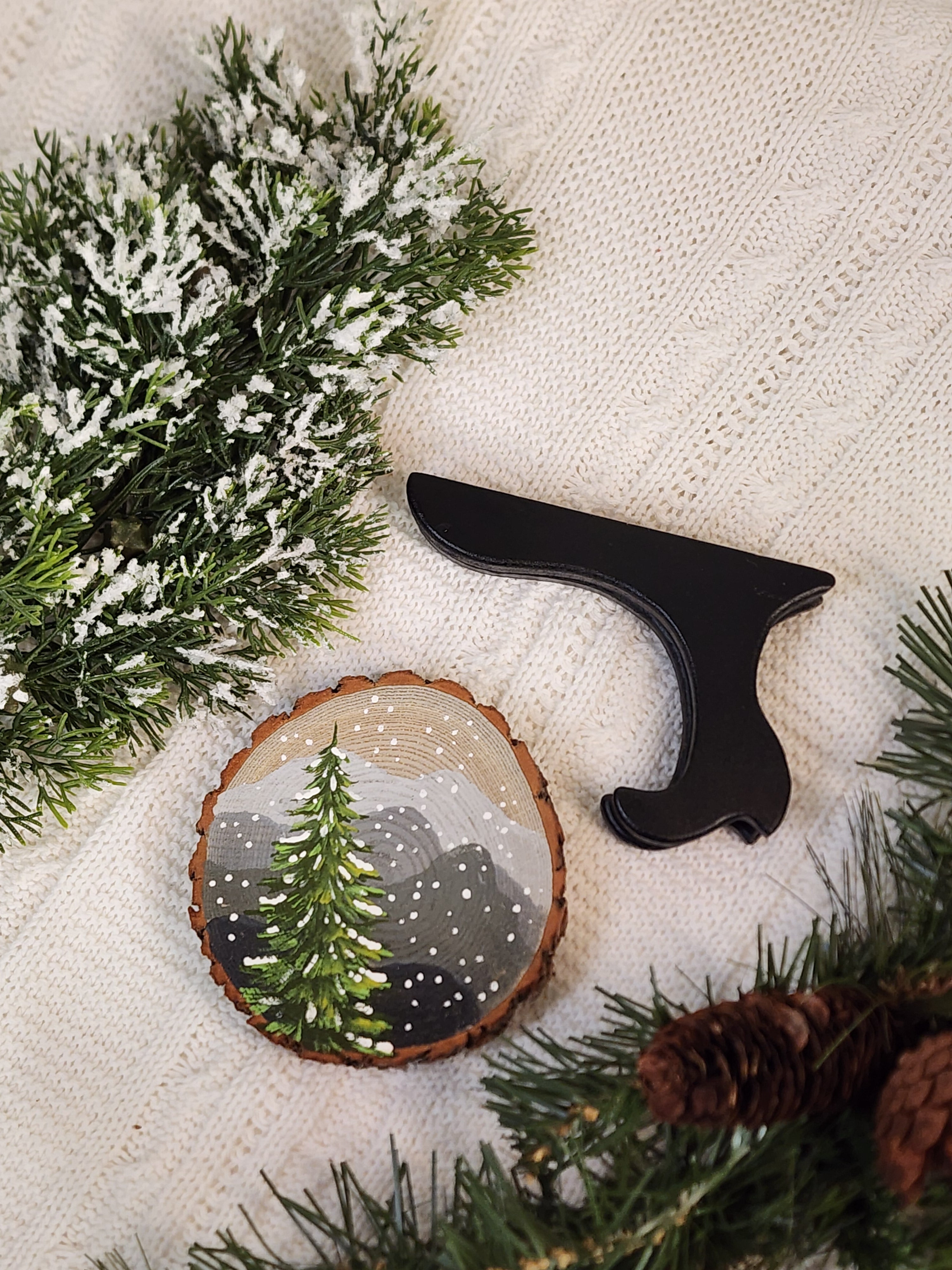 Large Hand Painted Christmas snowy mountain artwork on hand cut wood slice, snow-covered pine tree, includes black frame stand