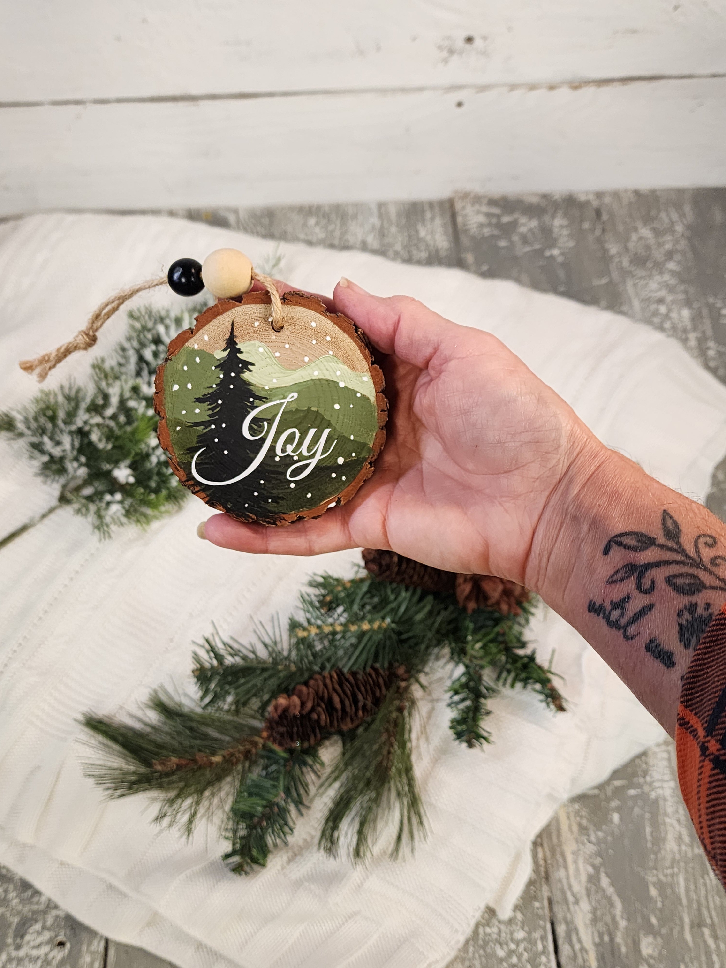 Hand-Painted Mountain Wood Slice Ornament • Rustic green mountains with JOY • Snowy Pine - Nature Christmas Decor • Handmade Holiday Gift