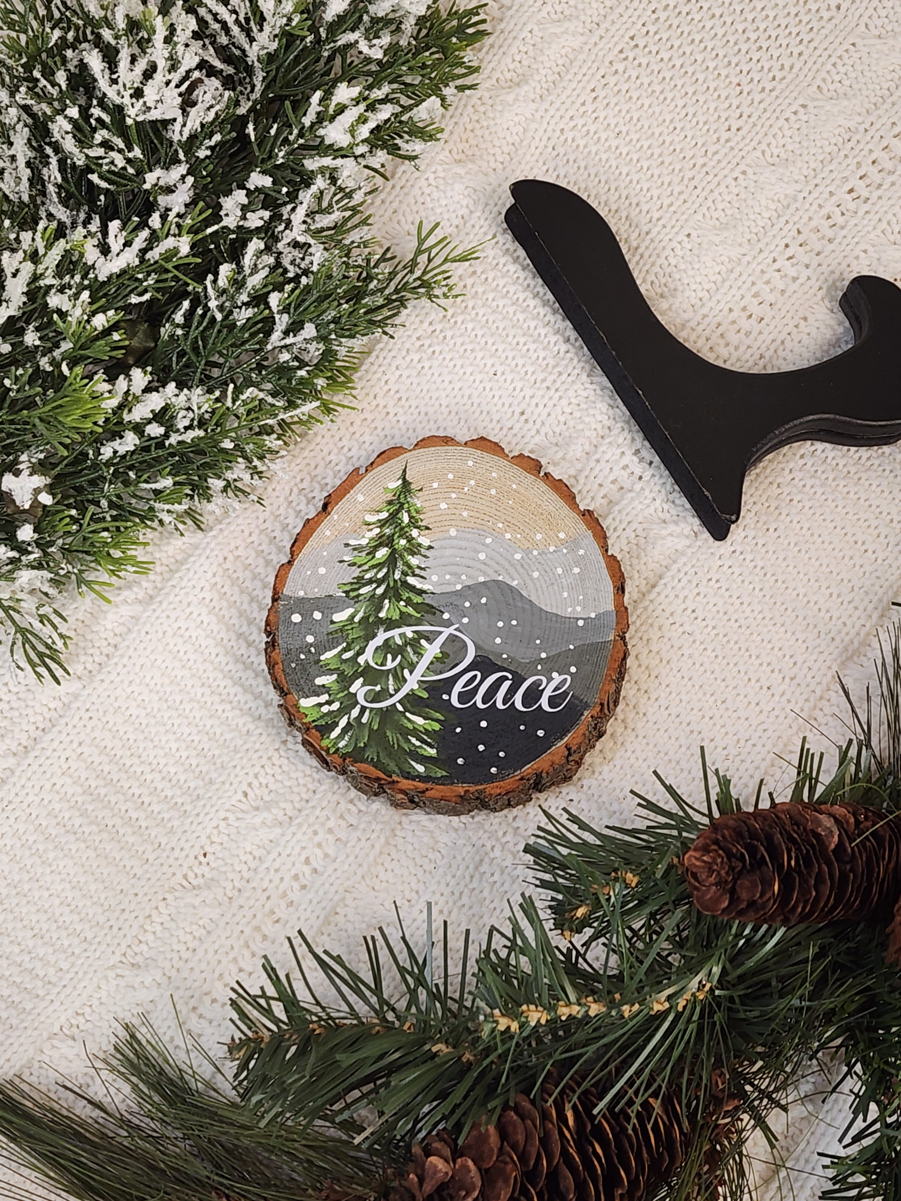 Large Hand Painted Christmas snowy mountain artwork on hand cut wood slice, snow-covered pine tree, includes black frame stand, Peace