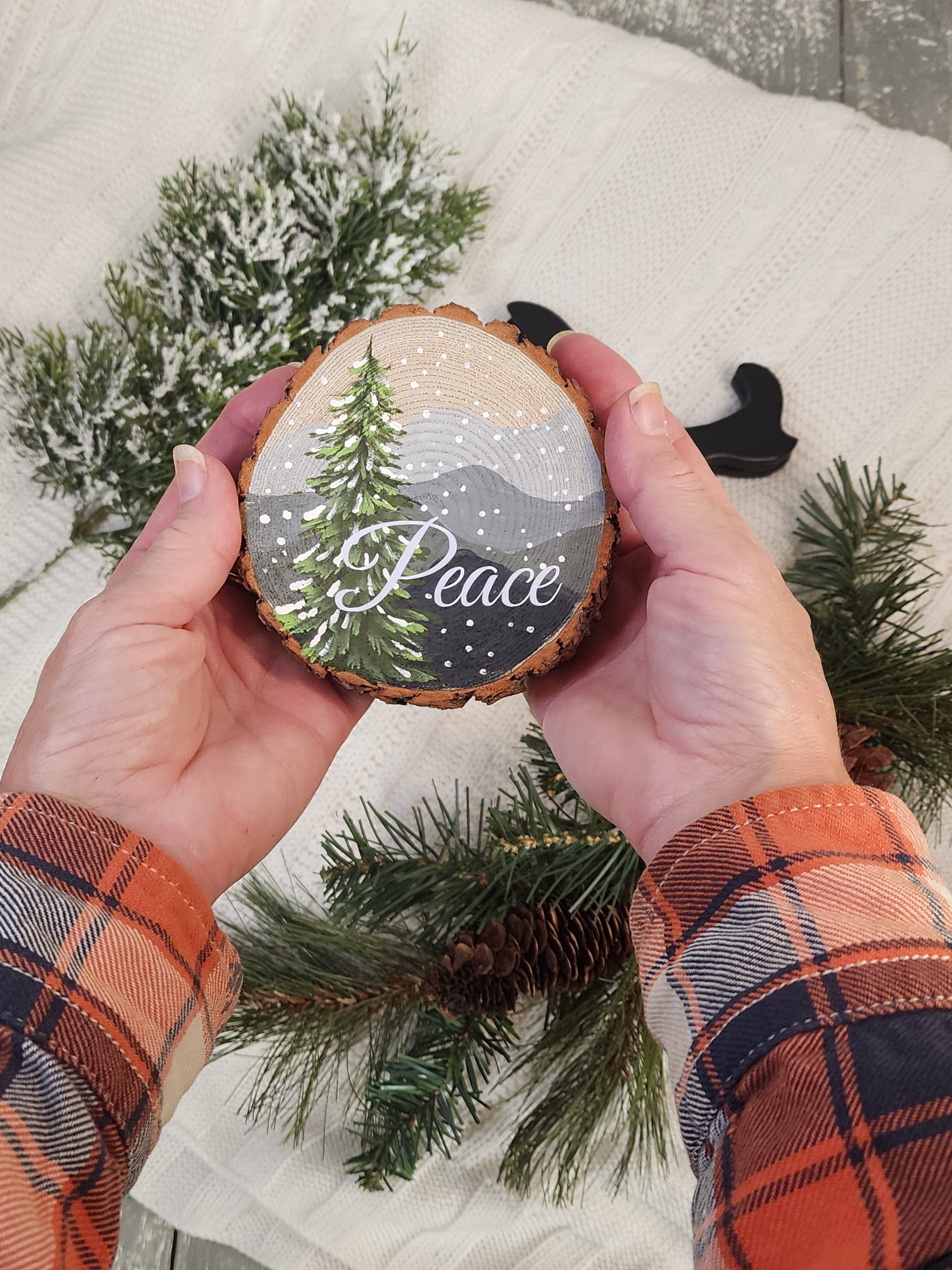 Large Hand Painted Christmas snowy mountain artwork on hand cut wood slice, snow-covered pine tree, includes black frame stand, Peace